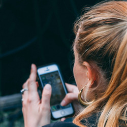 Eine Frau tippt auf ihrem Handy