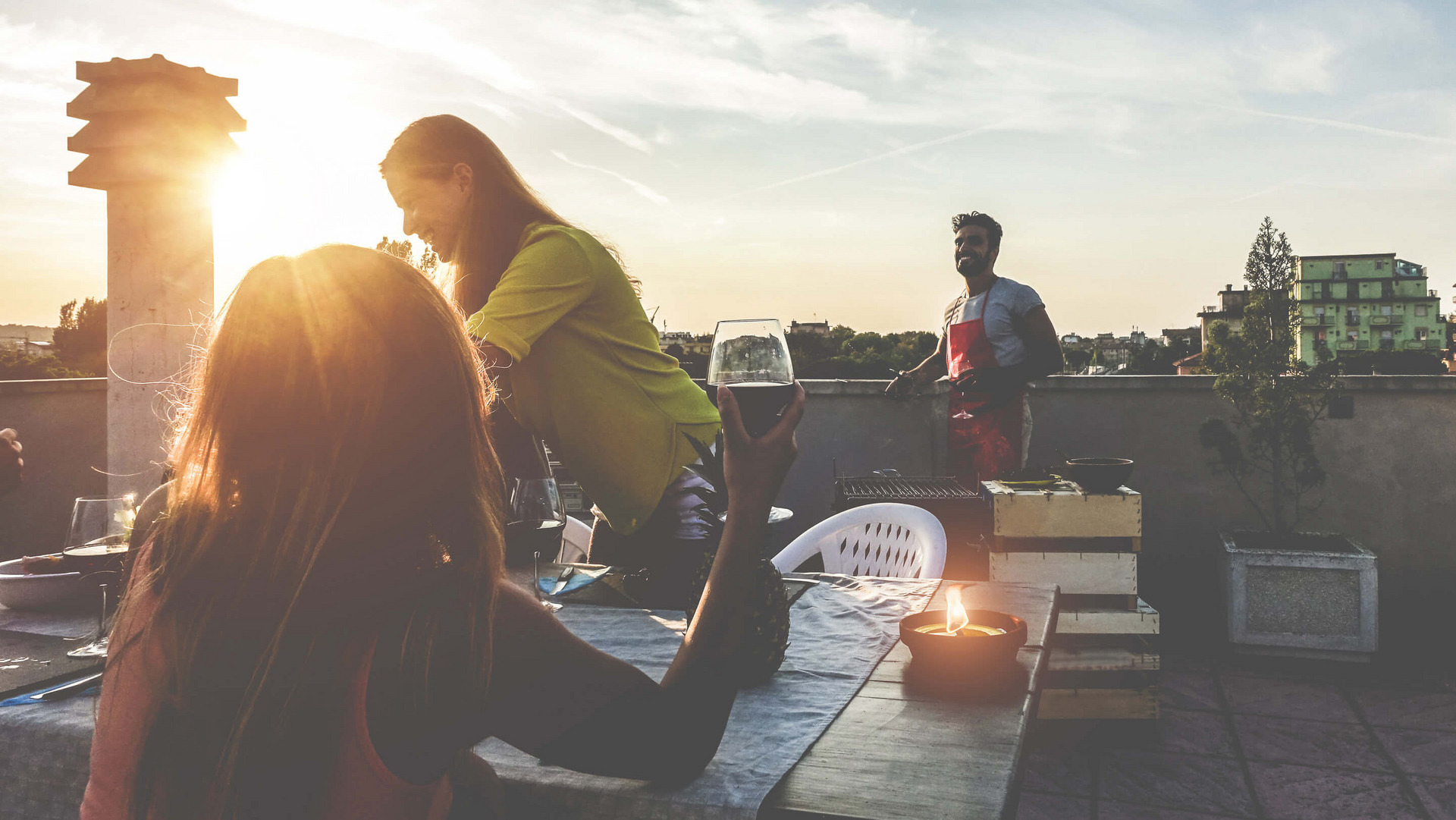 Freunde grillen abends auf dem Dach